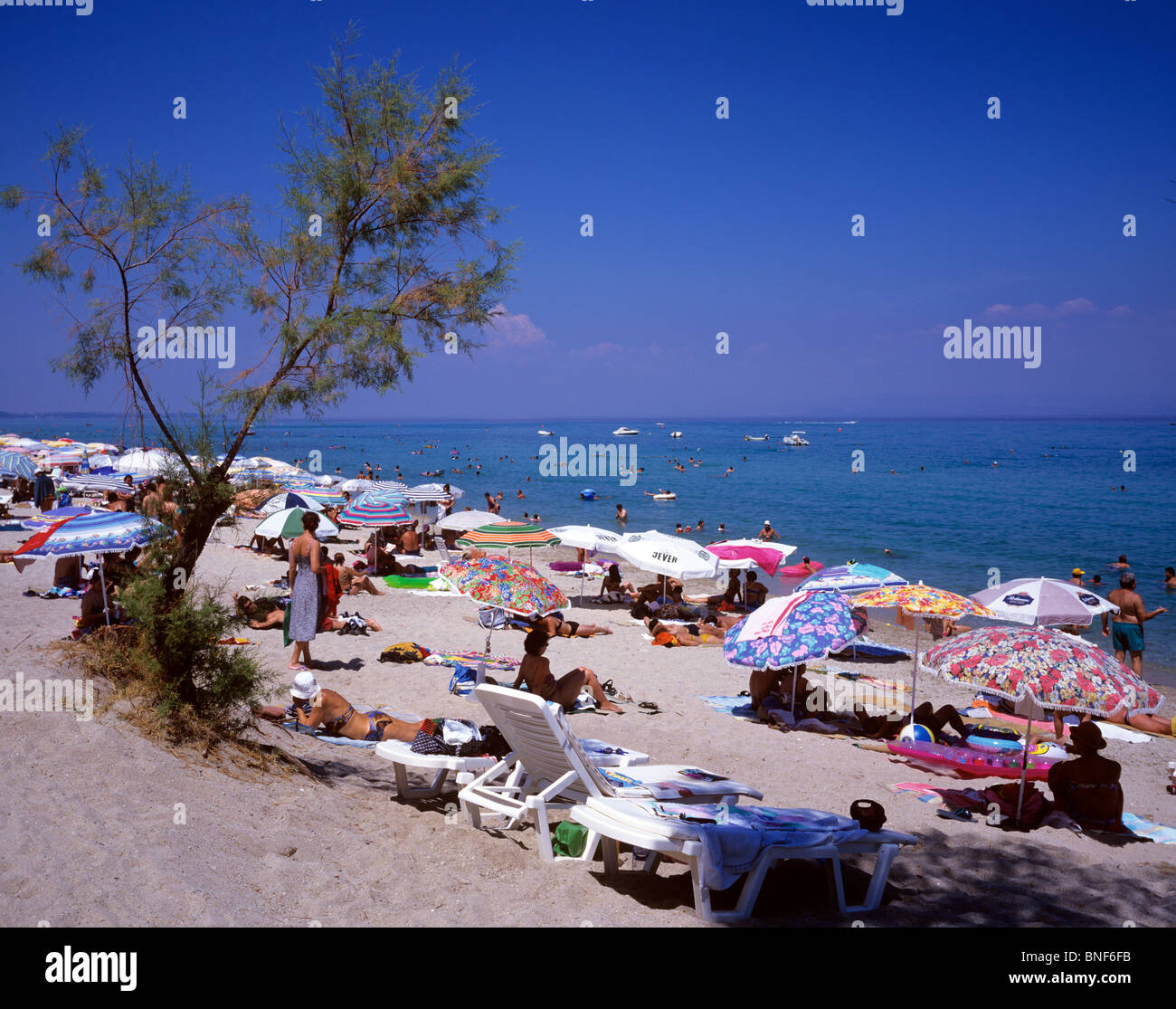Beach scene at the popular resort of Chaniotis on the east coast of the Kassandra Peninsula Stock Photo