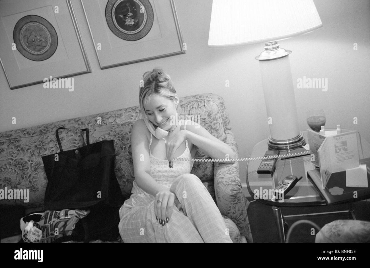 Young woman talking on a landline phone Stock Photo