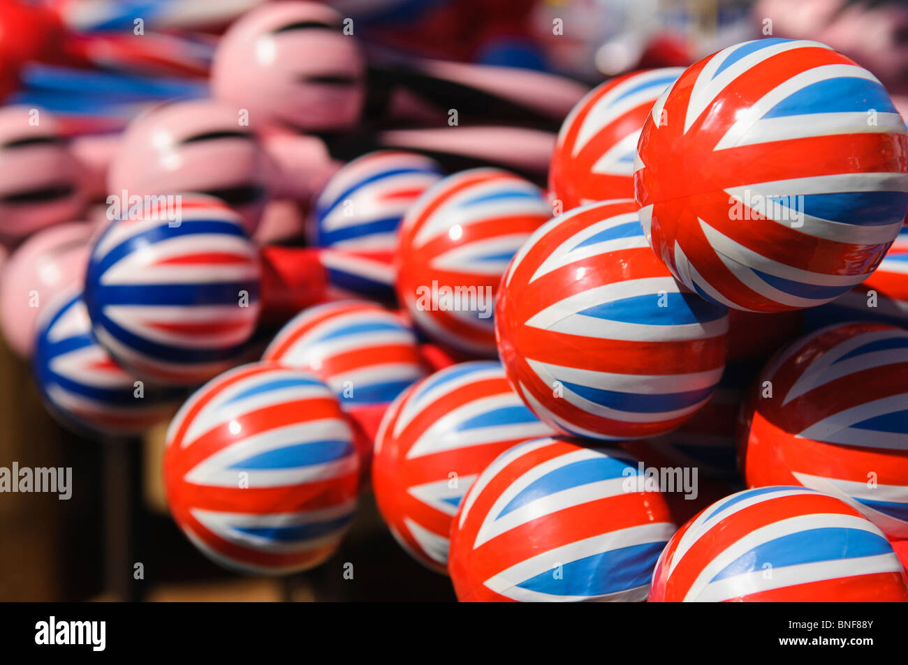 Red, white and blue union jack band sticks on sale on a stall during a  Twelfth of July parade Stock Photo - Alamy
