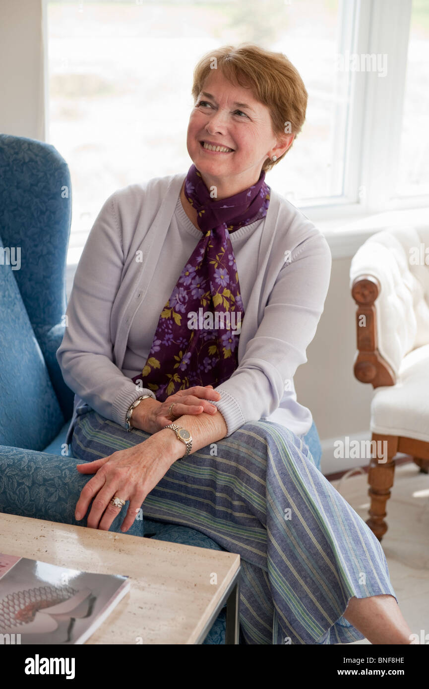 Mature woman smiling in living room Stock Photo - Alamy