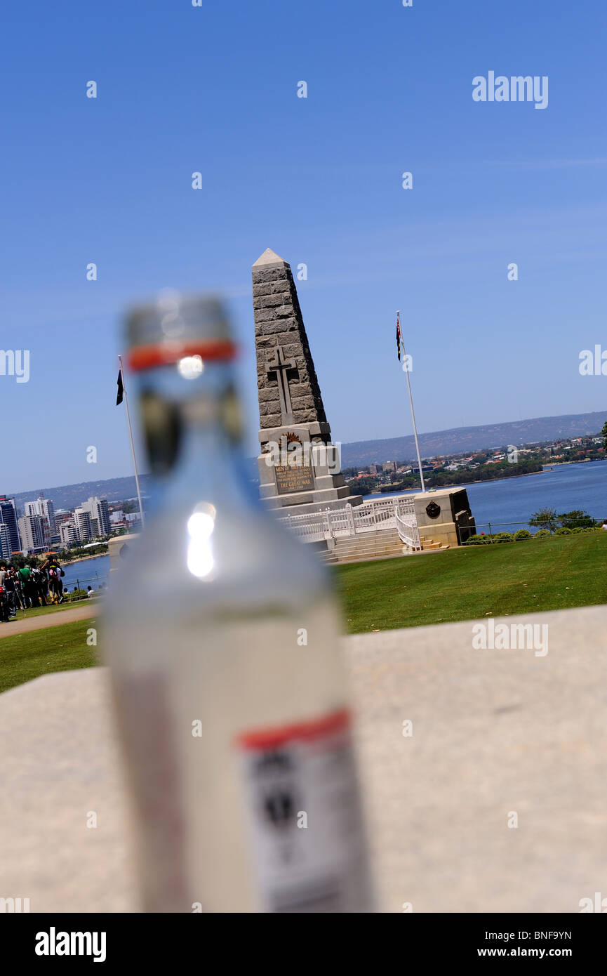 King's Park War memorial, obscured by empty vodka bottle, showing that everything can be distorted by alcohol. Kings Park, Perth, Western Australia Stock Photo