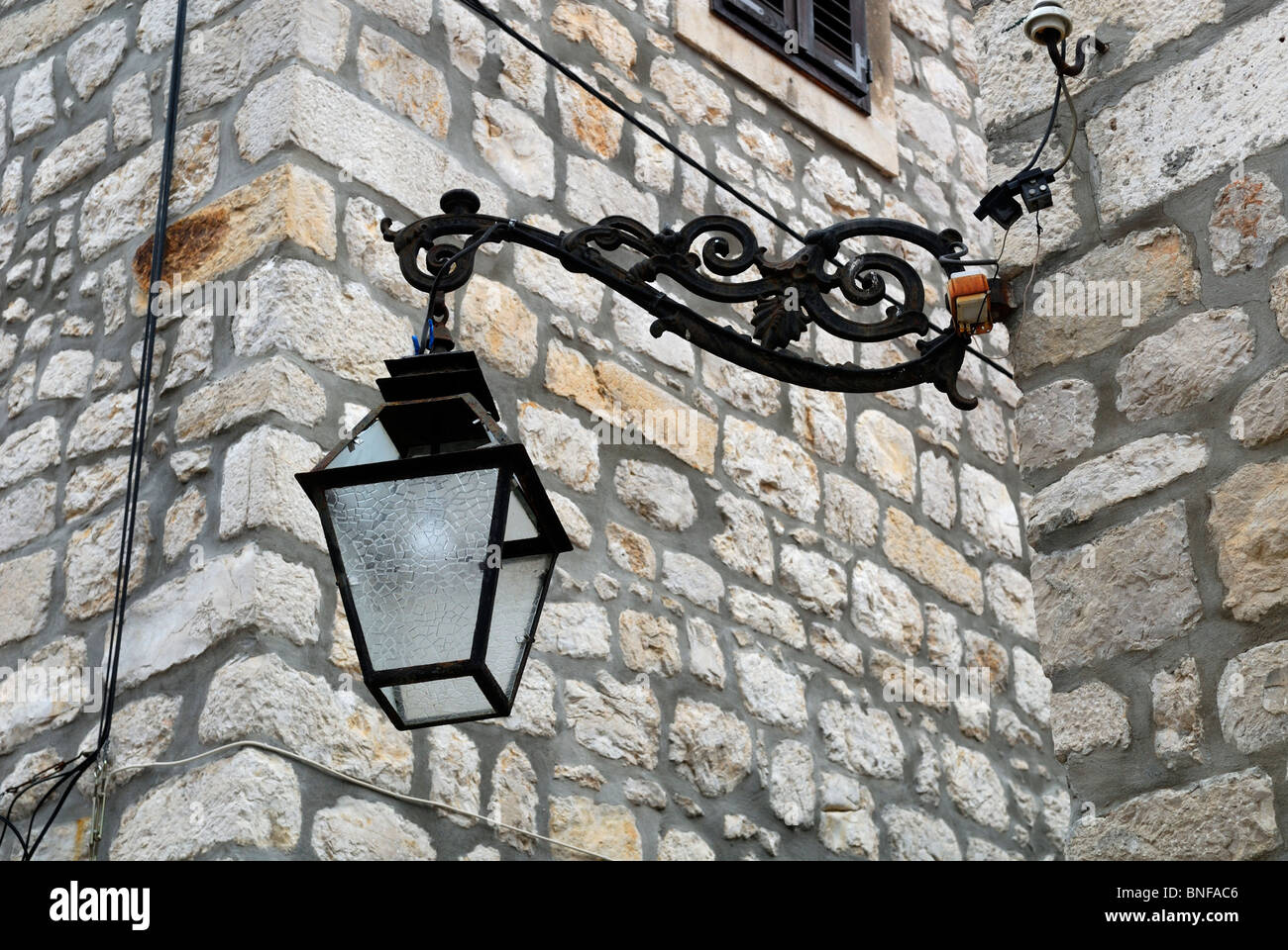 Electric street lamp on ornate wrought iron bracket. Dubrovnik, Croatia Stock Photo