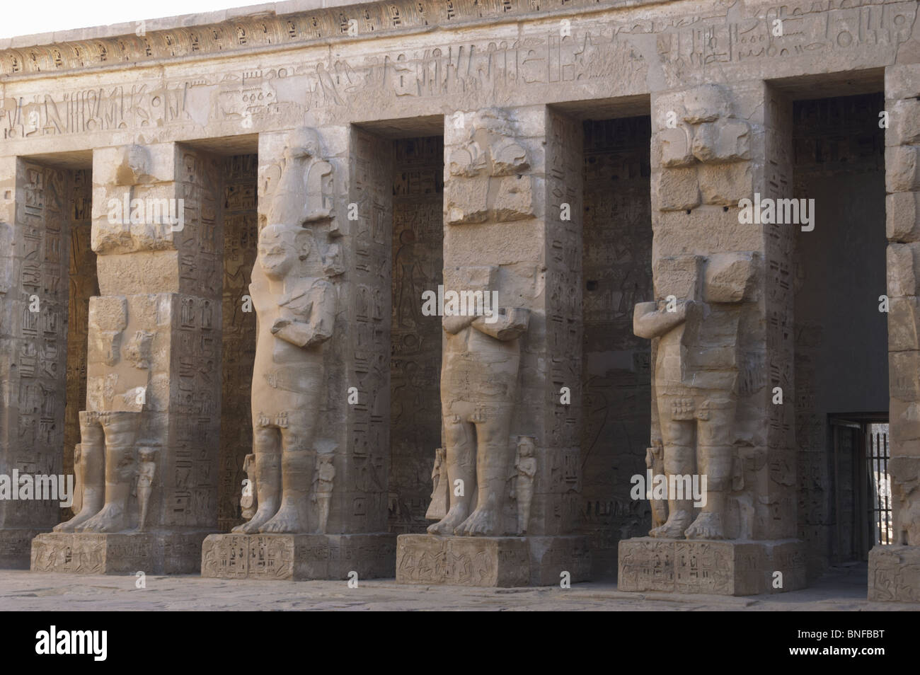 Temple of Ramses III. Great colossal statues of Ramses III deified as Osiris, attached to pillars. Egypt. Stock Photo