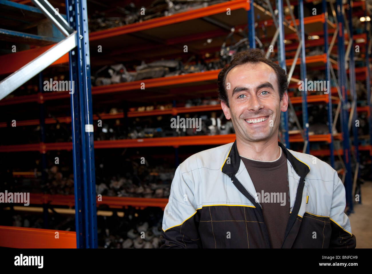 Mechanic smiling on a warehouse Stock Photo