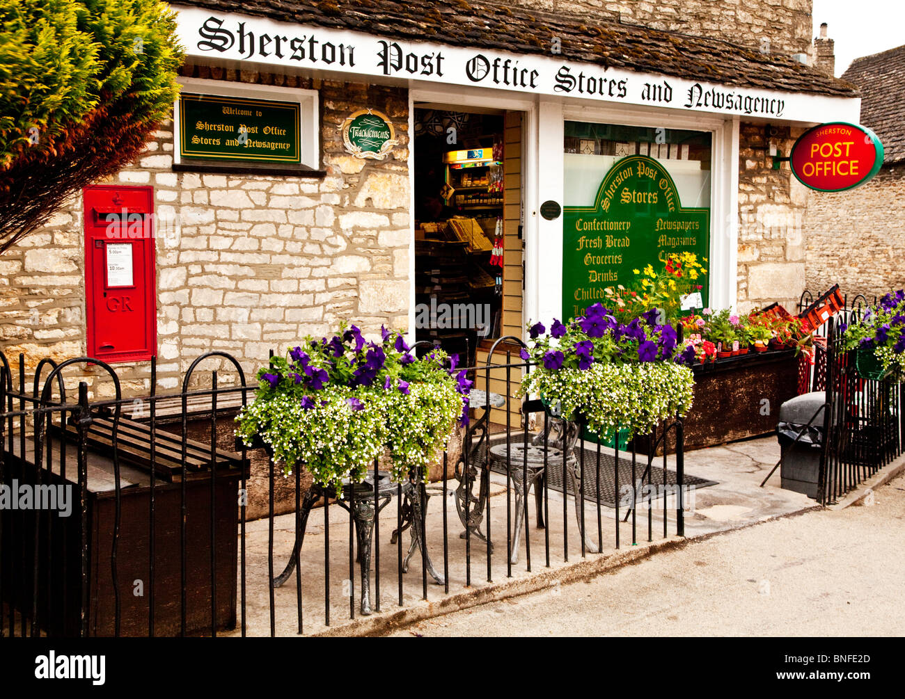 Typical English country grocers shop, newsagent and Post Office in the Cotswold village of Sherston, Wiltshire, England, UK Stock Photo