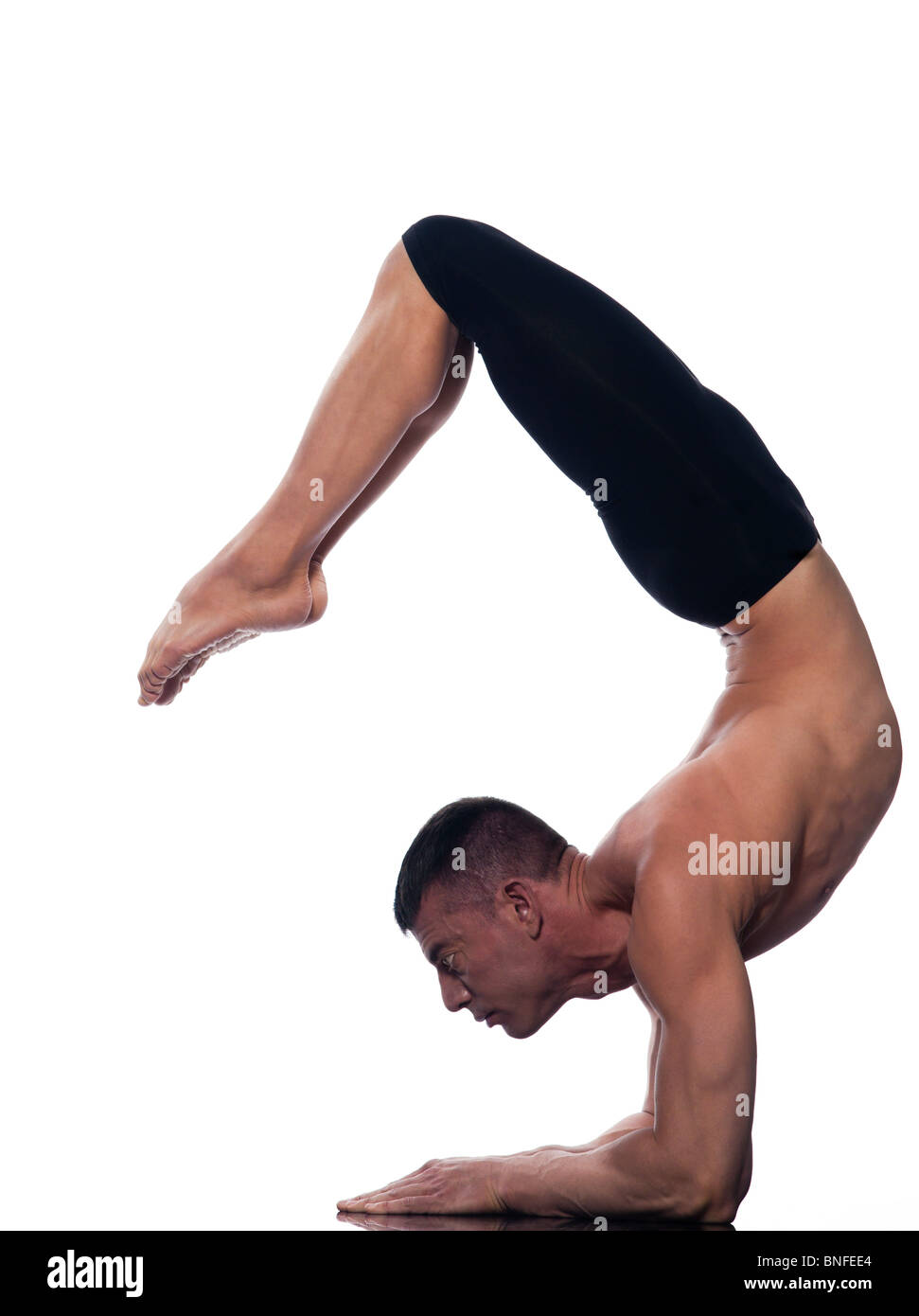caucasian man scorpion pose Vrschikasana gymnastic acrobatics isolated studio on white background Stock Photo
