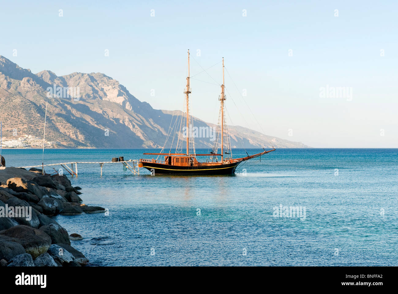 Wooden sailing boat mooring to the shore next to Kardamena, Kos Island, Greece Stock Photo