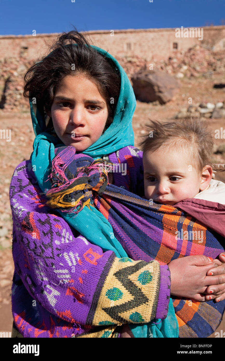 Young woman living on traditional farm with baby boy, near Telouet, High Atlas Mountains, Morocco Stock Photo