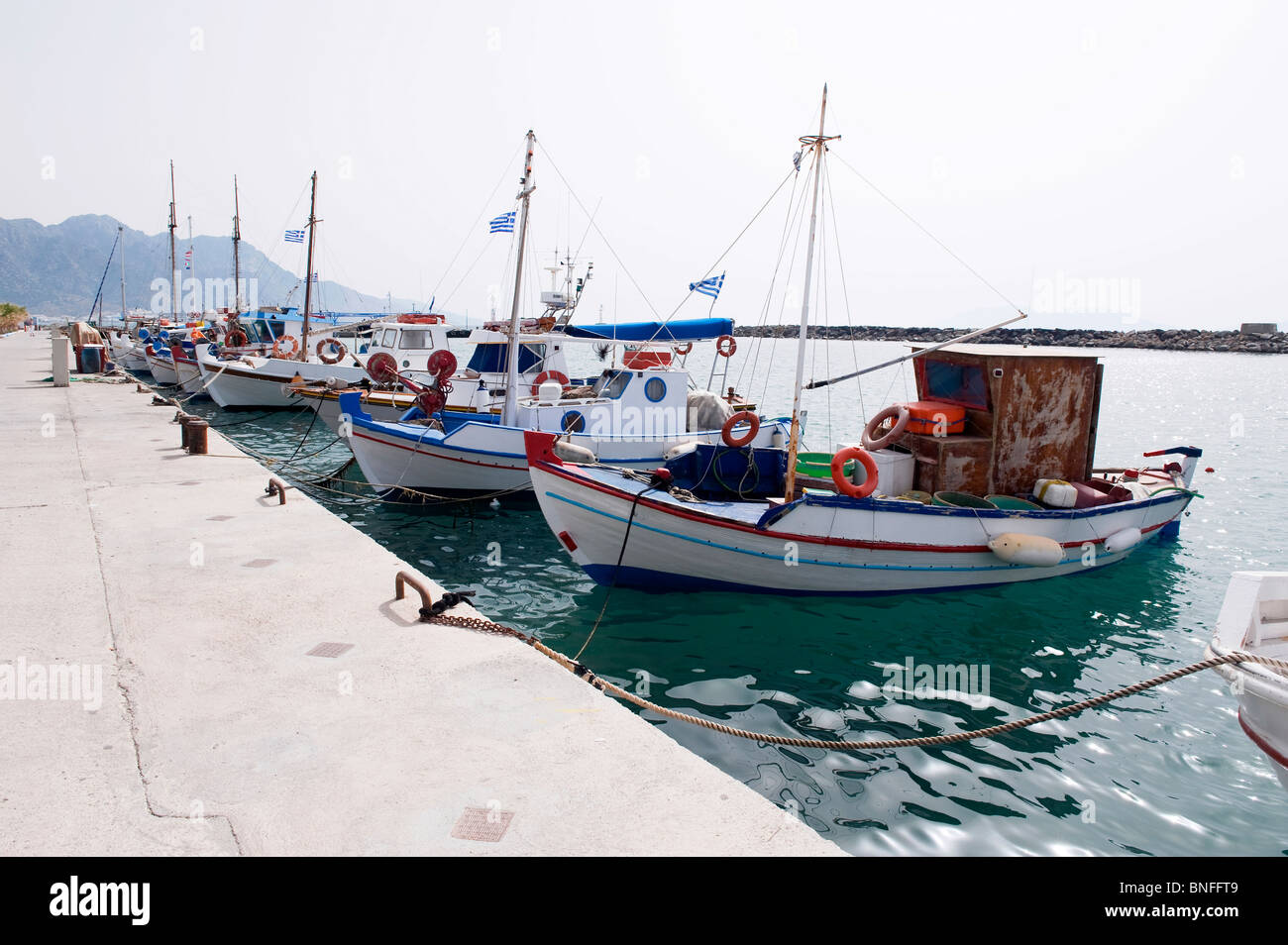 Fishing Boats moored to quay Kardamena Harbor Kos Island Greece Stock Photo