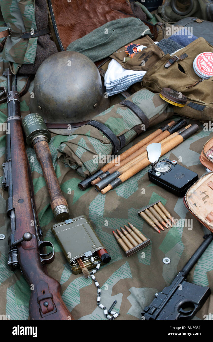 WW2 German army soldiers equipment including hand grenade, rifle, bullets, helmet and a pistol Stock Photo