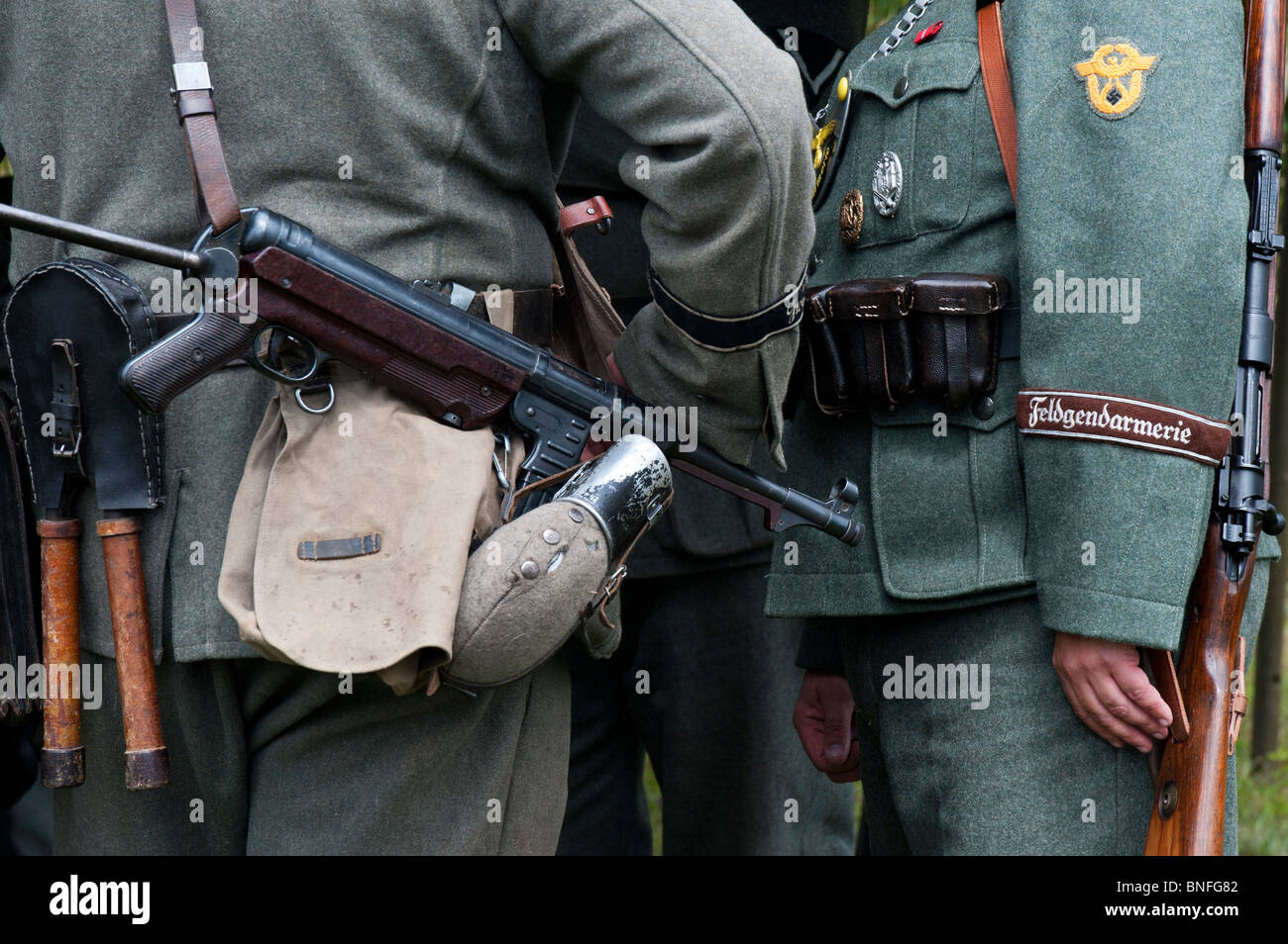 WW2 German army soldier with officer carrying MP40 9 mm submachine gun. Historical re enactment. Stock Photo