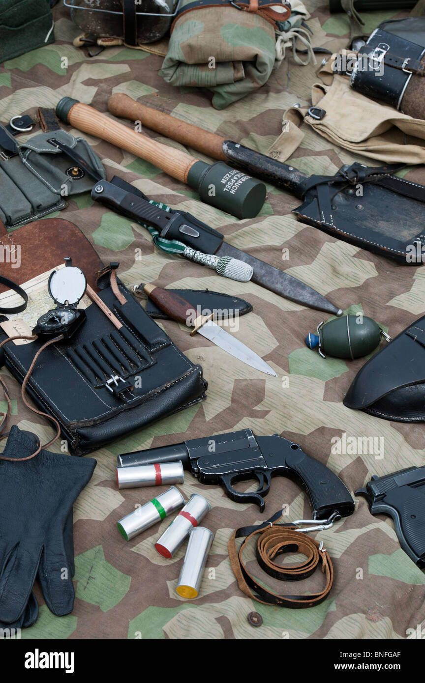 WW2 German army soldiers equipment including stick grenade, knife, flare gun, shovel, hand grenade and compass and a map case Stock Photo