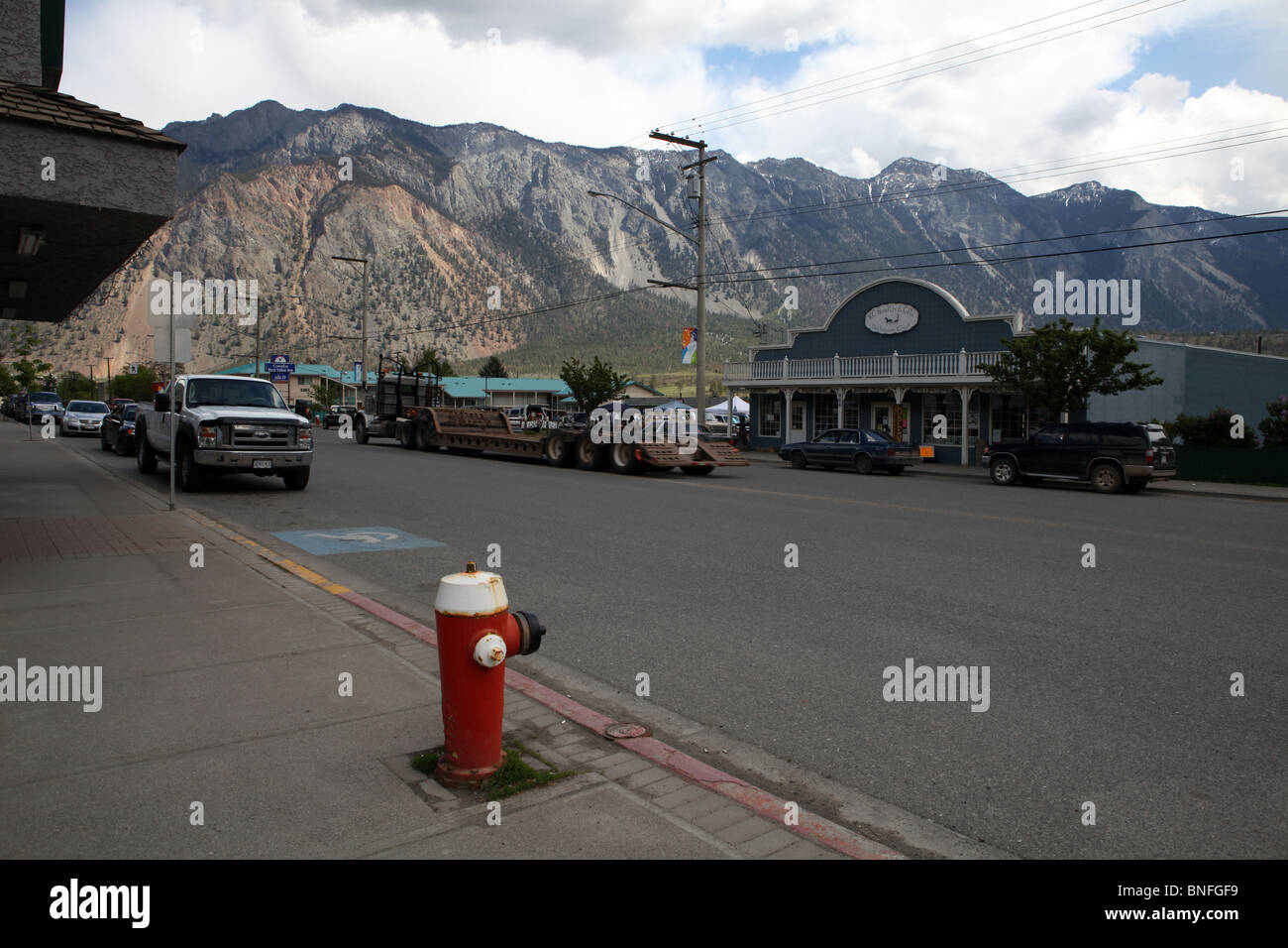 Red fire hydrant on main street and surrounding mountains Lillooet