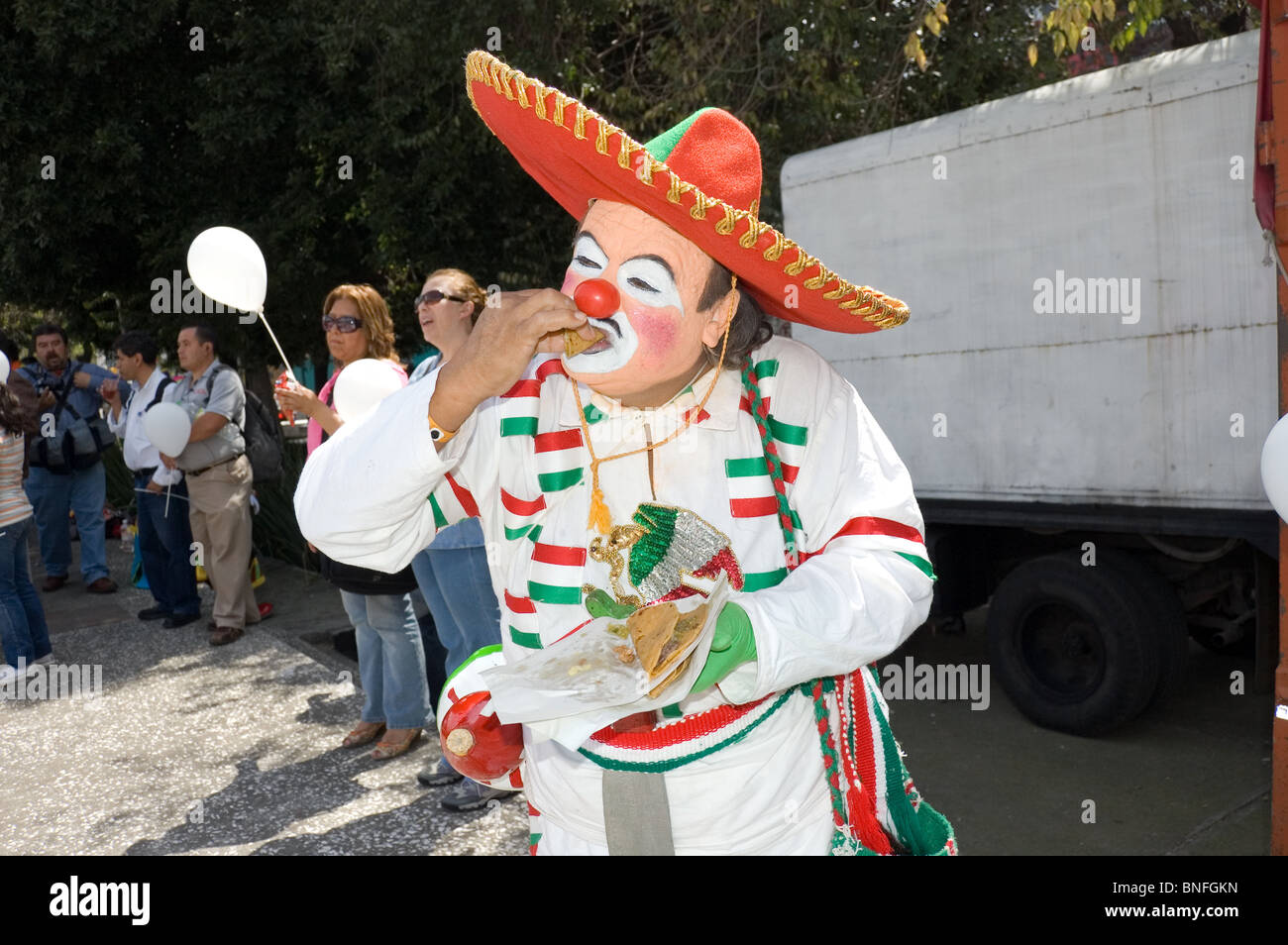 mexican-clown-eating-a-taco-during-a-clown-parade-in-mexico-city-with-BNFGKN.jpg