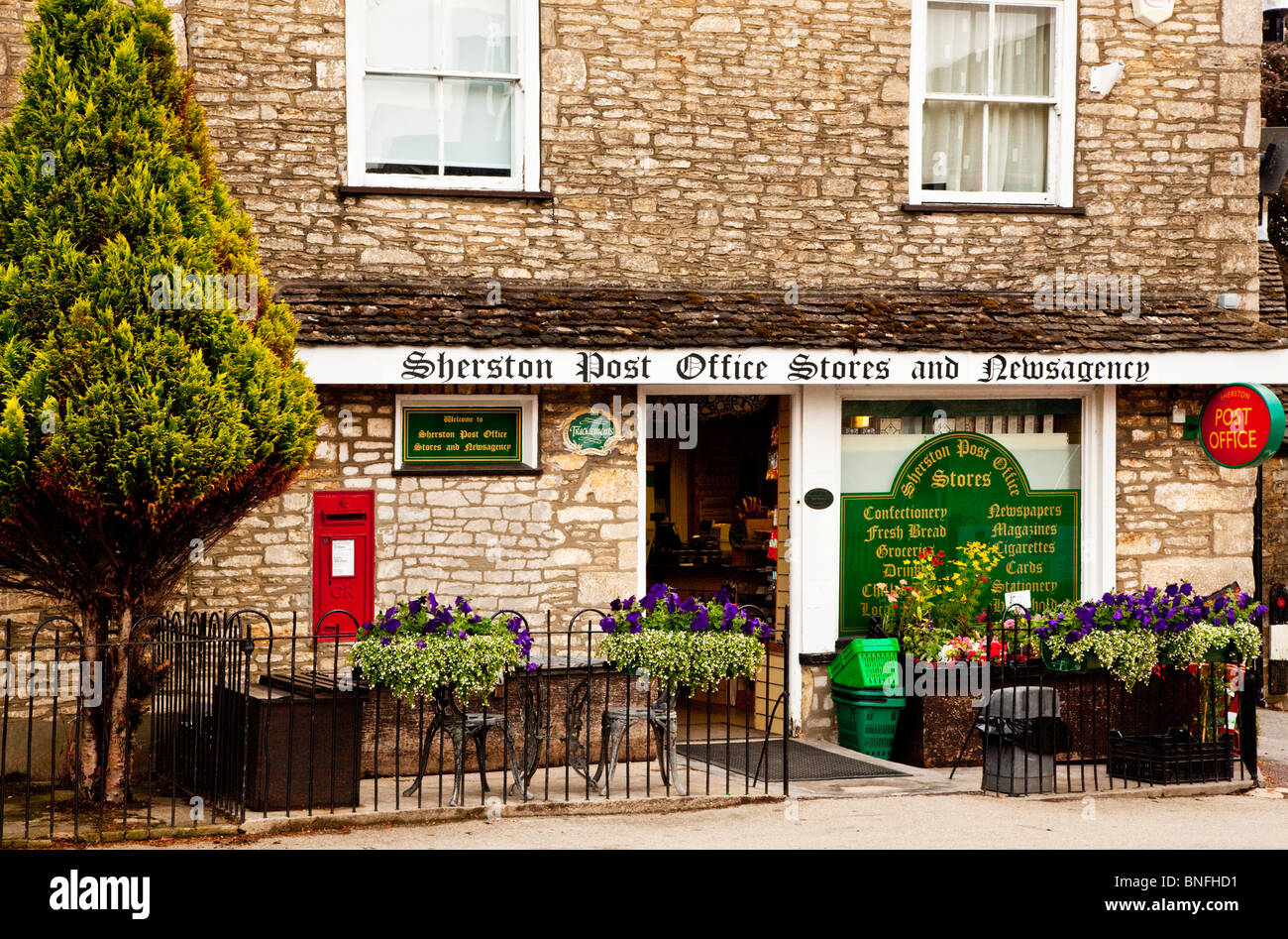 Typical English country grocers shop, newsagent and Post Office in the Cotswold village of Sherston, Wiltshire, England, UK Stock Photo