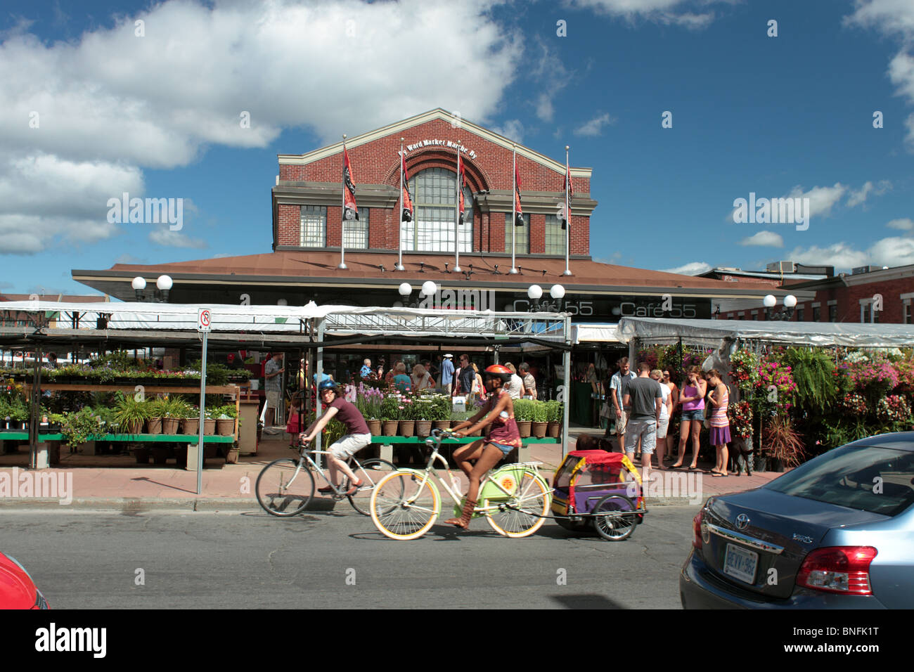 Family Cycle Towing A Child Carrier Past The Ottawa Byward Market On A Sunday Morning, Editorial Use Only Stock Photo