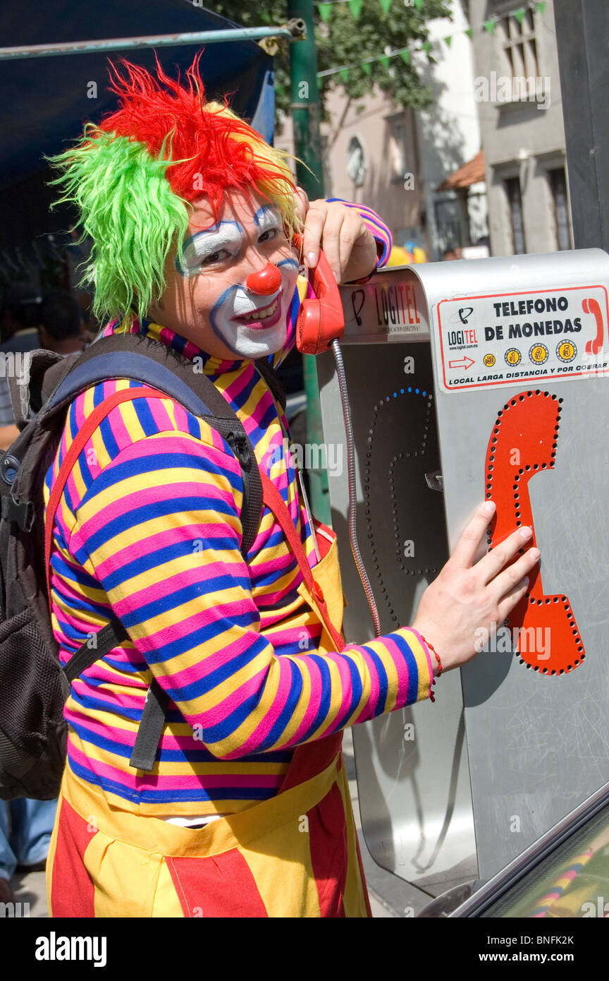 Clown using telephone during a clown parade in Mexico city with clowns