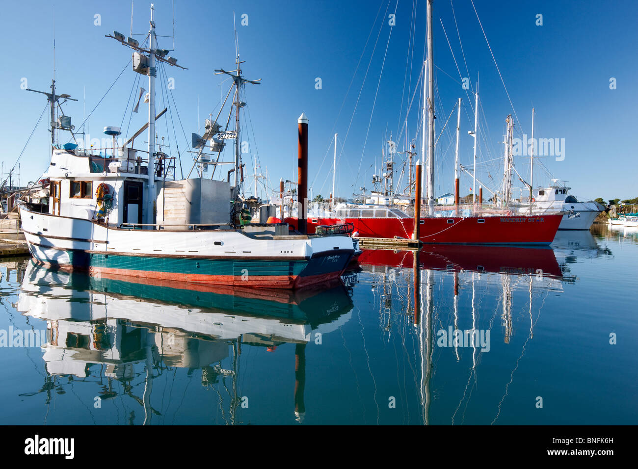 Boats in Brookings Harbor with reflection. Oregon Stock Photo