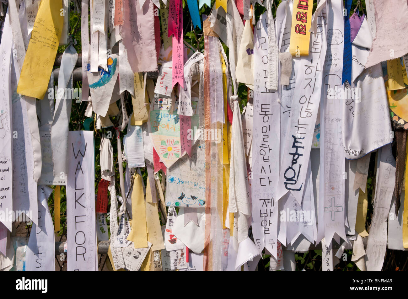 Messages and flags pinned to the fence between North and South Korea within the Demilitarized Zone (DMZ), Imjingak, South Korea Stock Photo