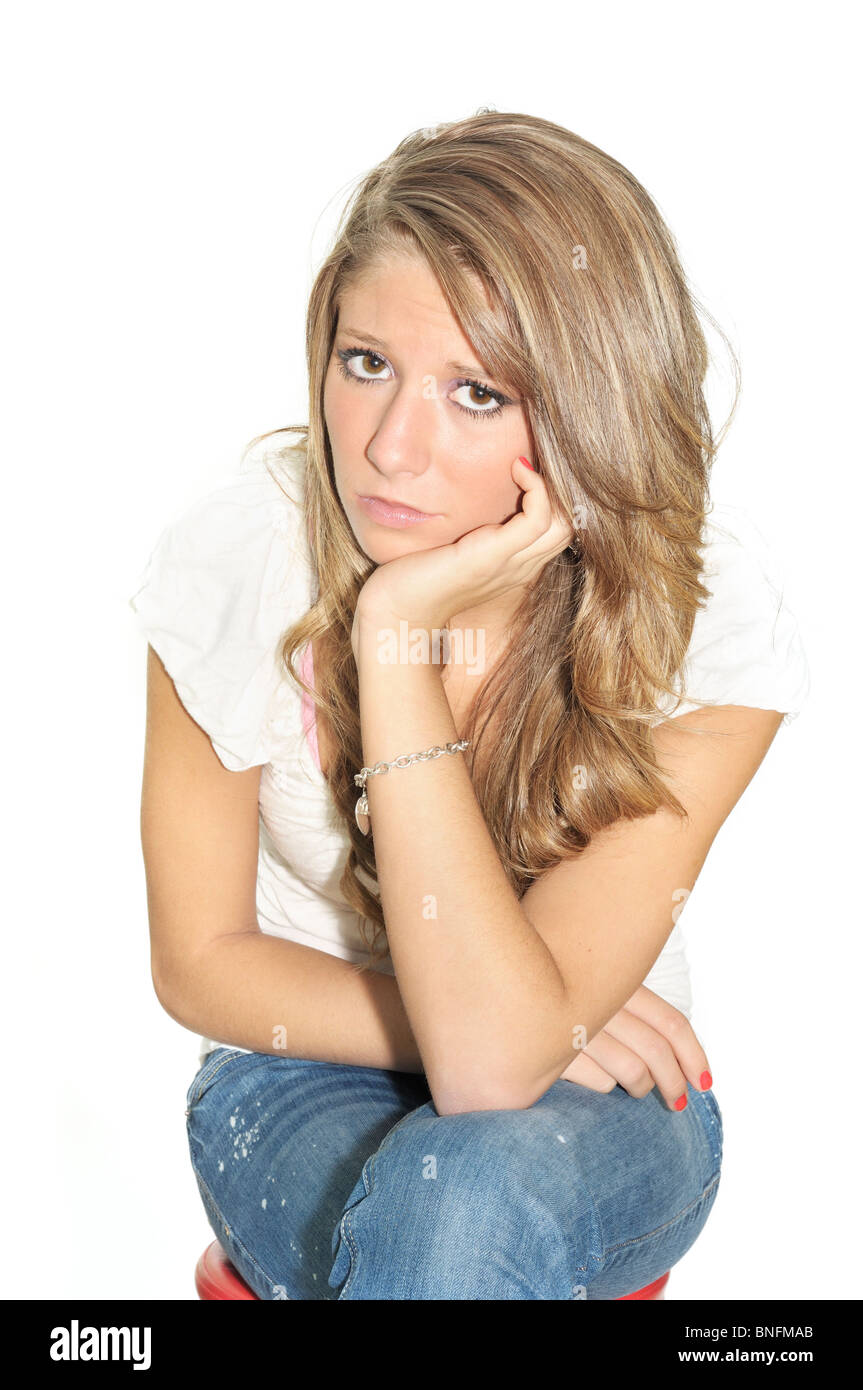 A pretty teenage girl looks sad and depressed. High key, cutout. Concepts Stock Photo