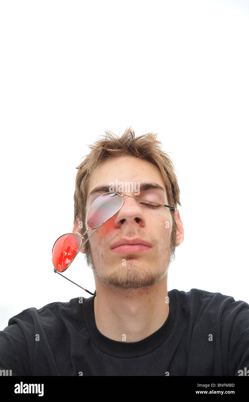 Glasses falling off face of a young man isolated on a white background Stock Photo Alamy