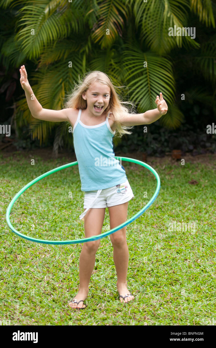 7 year old girl using a hula hoop Stock Photo - Alamy