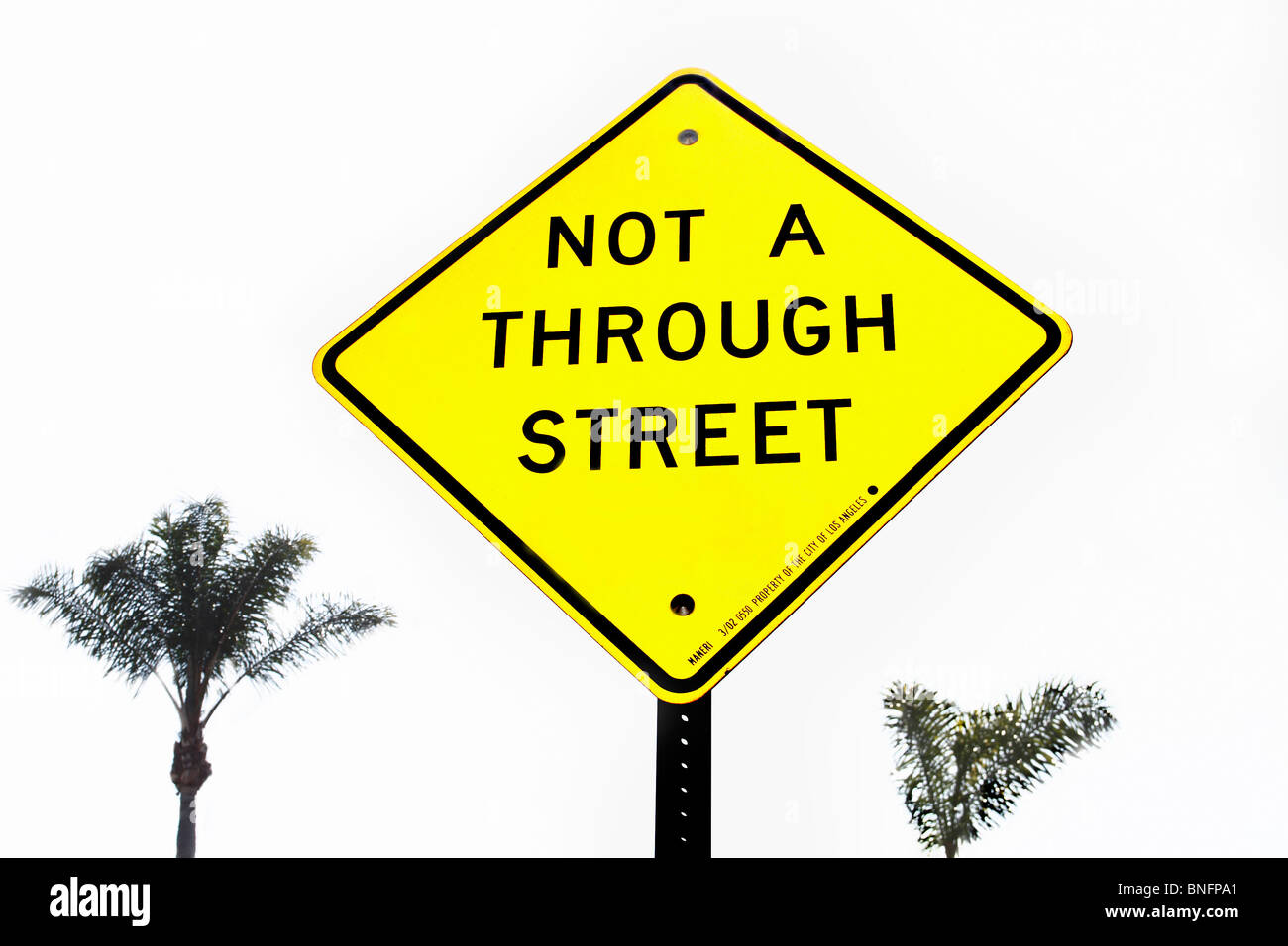 Not A Through Street Yellow traffic sign with Palm trees Stock Photo