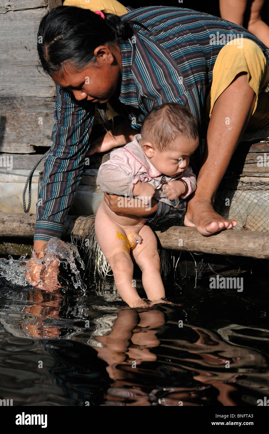 Mother washing her son in the waters of Tonle Sap Lake, Cambodia Stock  Photo - Alamy