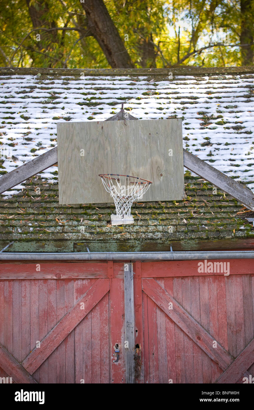 Barn with basketball hoop and snow, Bozeman, Montana, USA Stock Photo