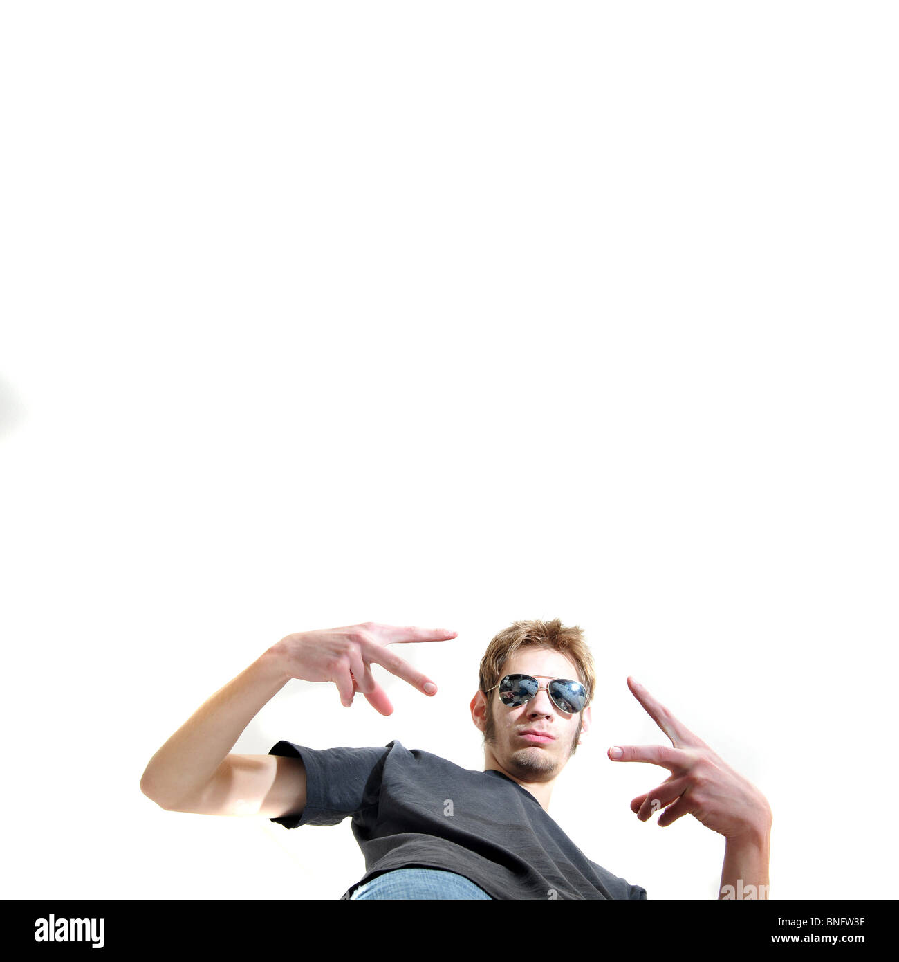 Gangsta with gun pointing down towards camera isolated on white background. Stock Photo