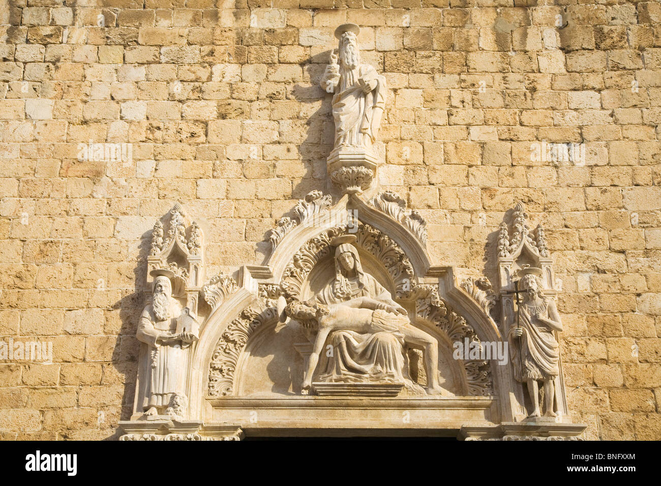 Croatia, Dalmatia, Dubrovnik, Sculpture on main portal of Franciscan Church Stock Photo