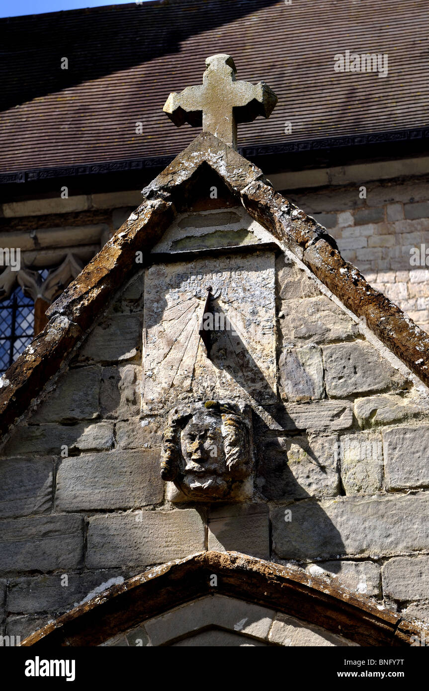Sundial and carving on porch of All Saints Church, Ladbroke, Warwickshire, England, UK Stock Photo
