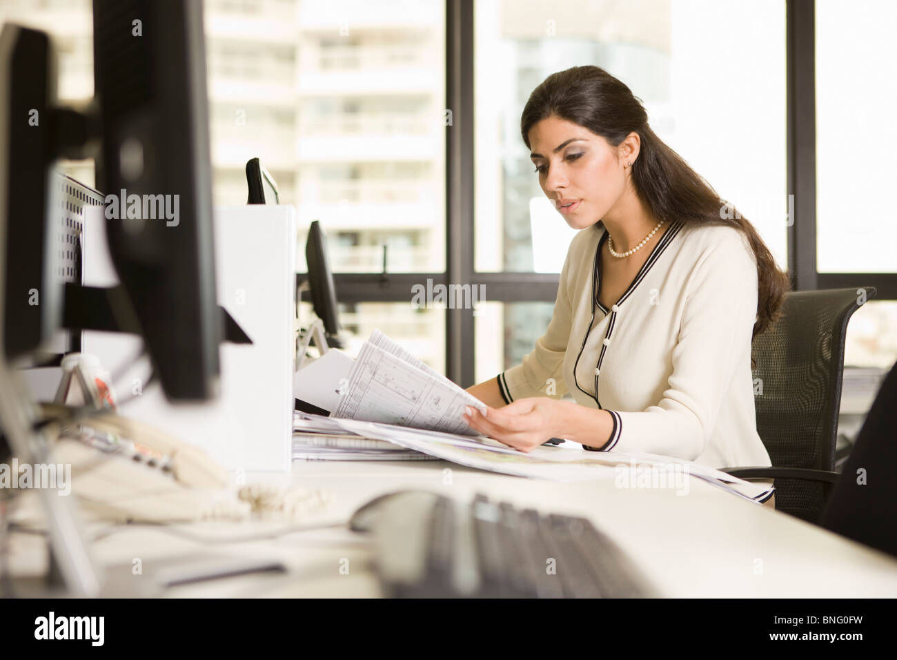 Businesswoman working in an office Stock Photo - Alamy