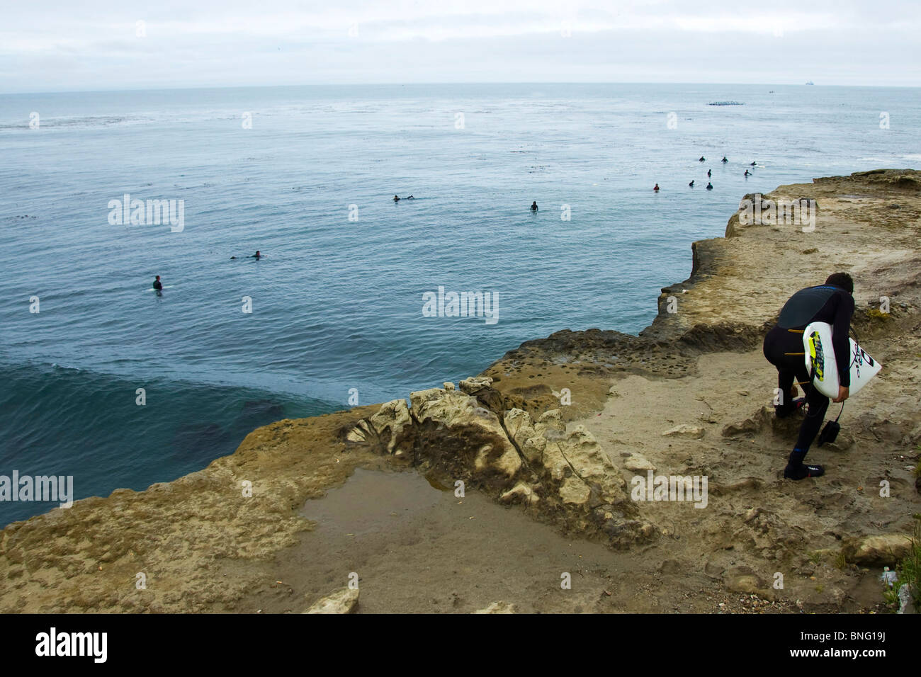 Surfer standing on a rock hi-res stock photography and images - Alamy
