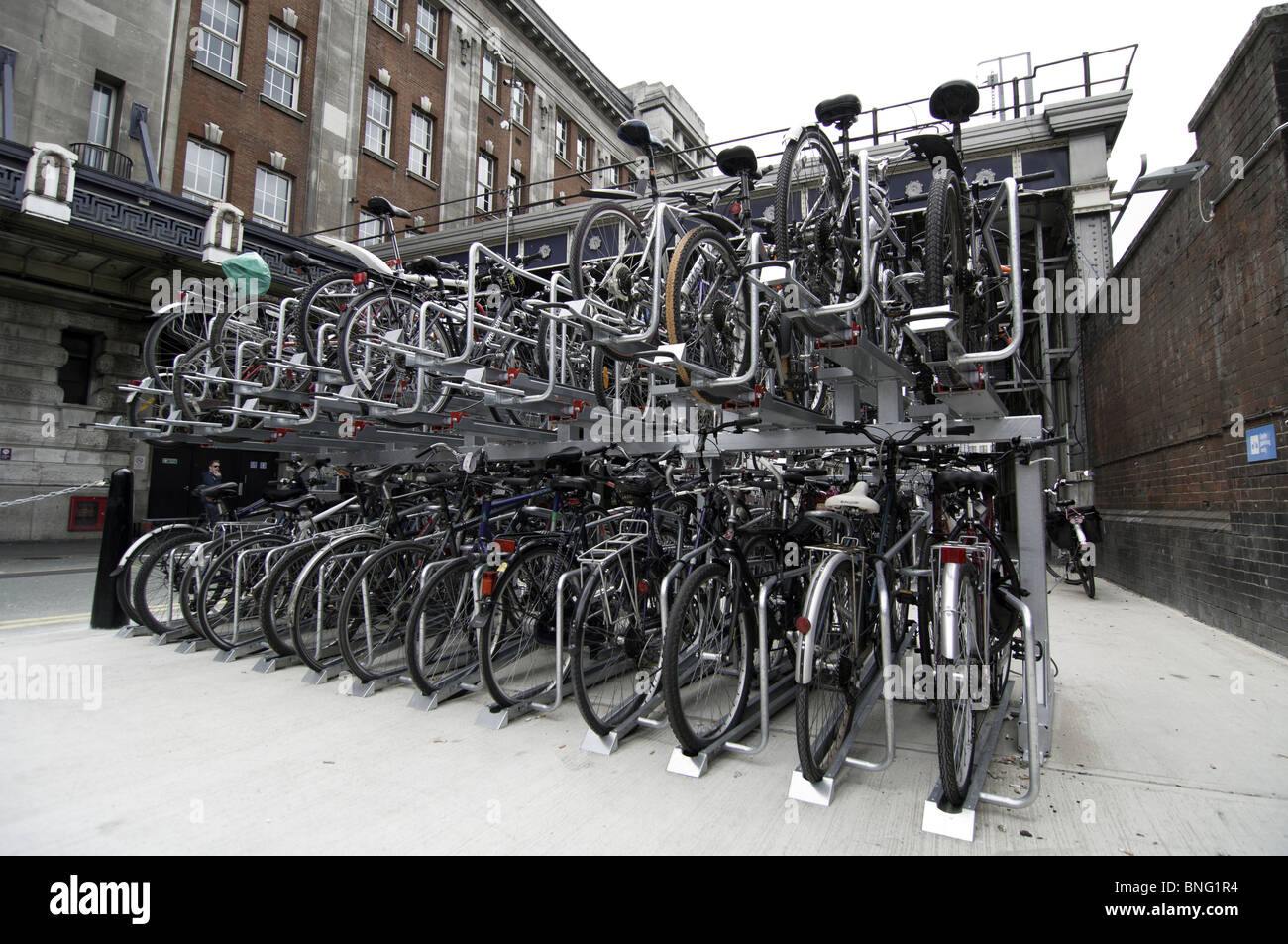 Bicycles staocked in parking racks at Waterloo Station London England
