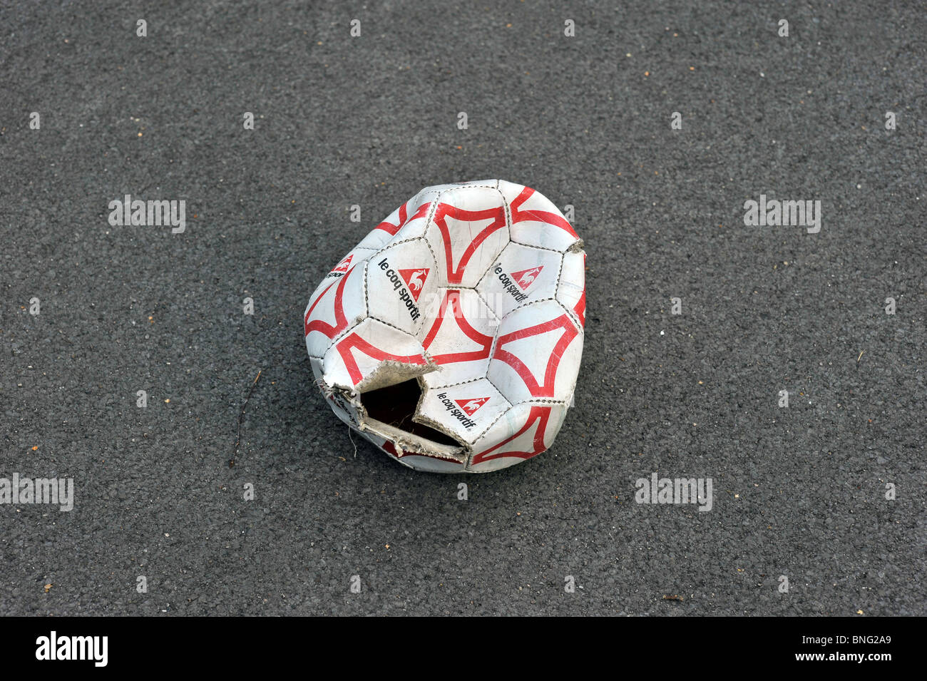 popped football Stock Photo Alamy