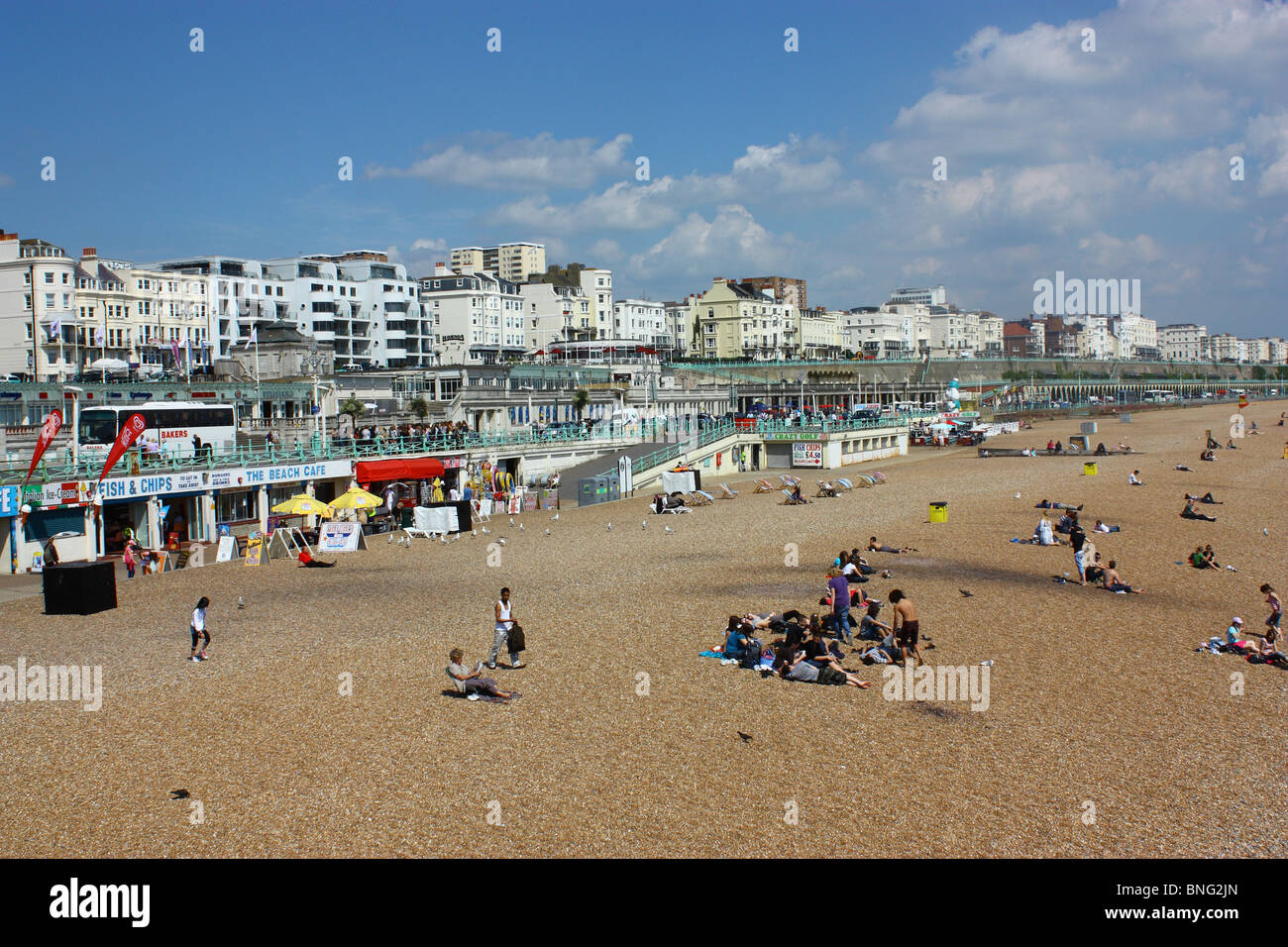A view of Brighton Beach from the pier looking East. The hotel line  disappears from view each having it's own views of the sea across golden sands. Stock Photo
