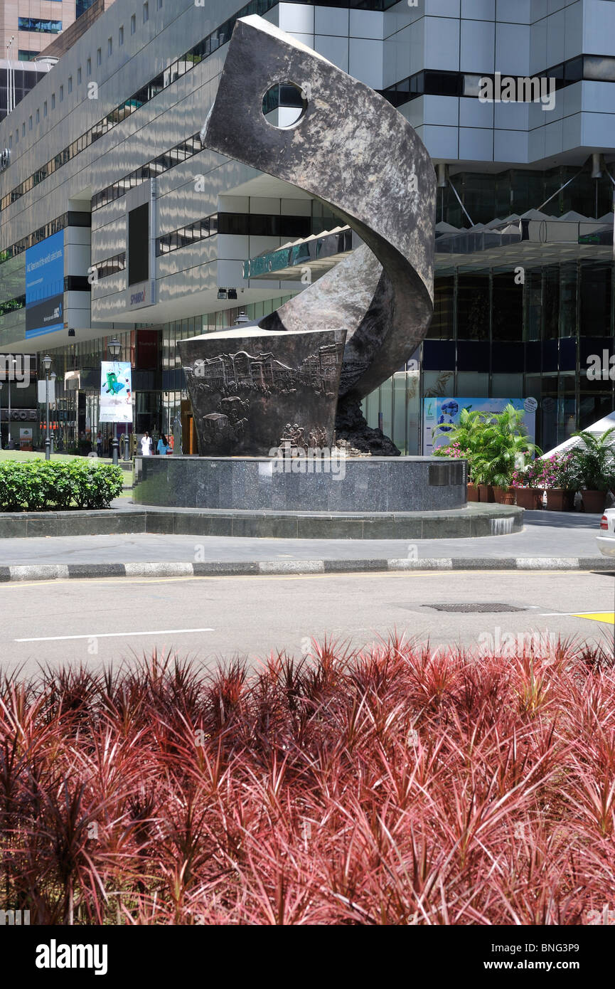 Modern sculpture in Raffles Square, Singapore. behind red grass Stock Photo