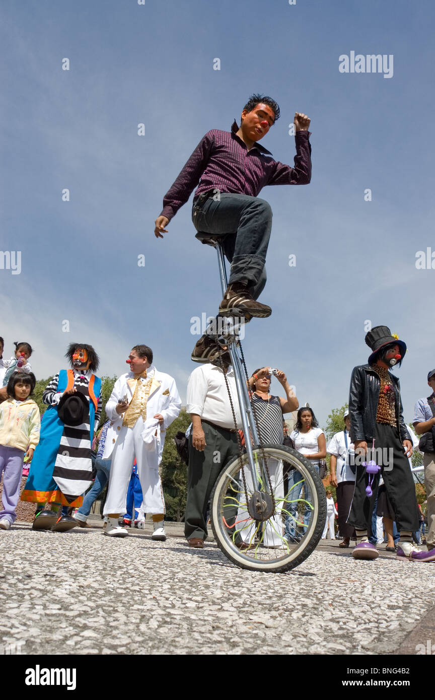 Clown riding an unicycle during a clown parade in Mexico city with clowns from several countries Stock Photo