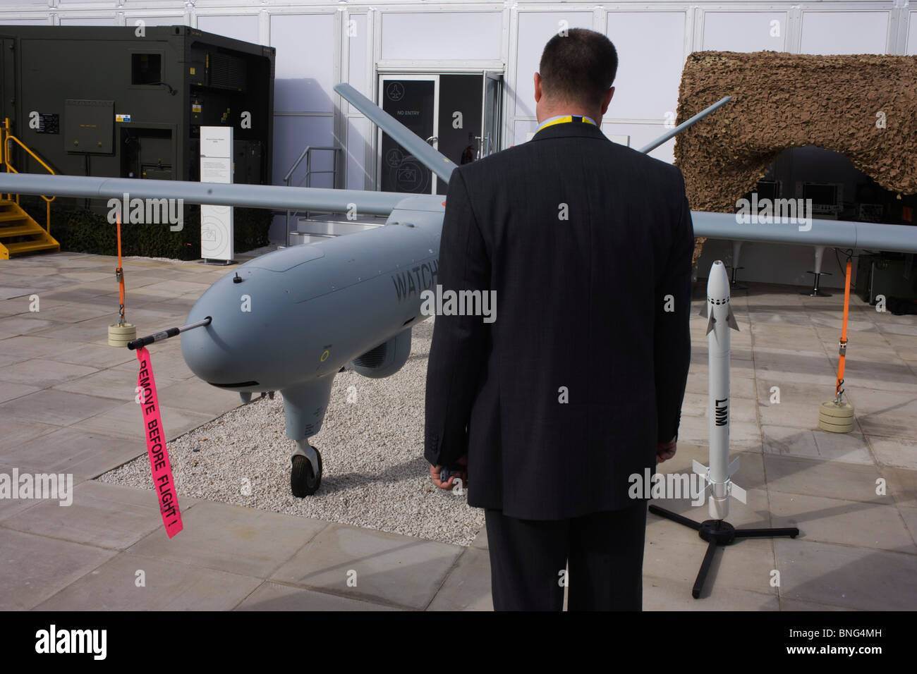 Guest inspects the Watchkeeper UAV drone of Aerospace manufacturer Thales hospitality chalet at the Farnborough Airshow. Stock Photo