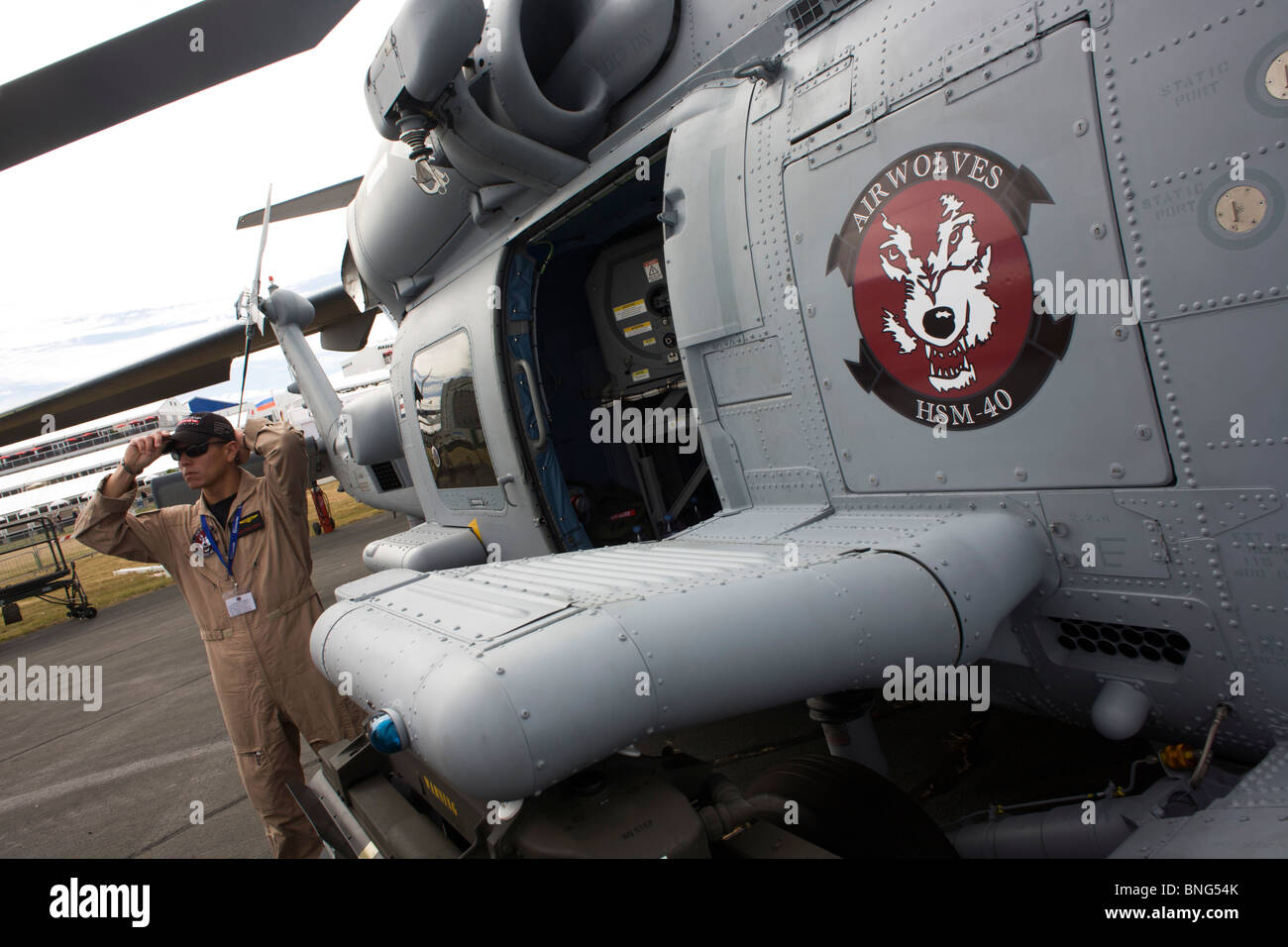 US Navy pilot and his Sikorsky MH-60R helicopter at the Farnborough Airshow. Stock Photo