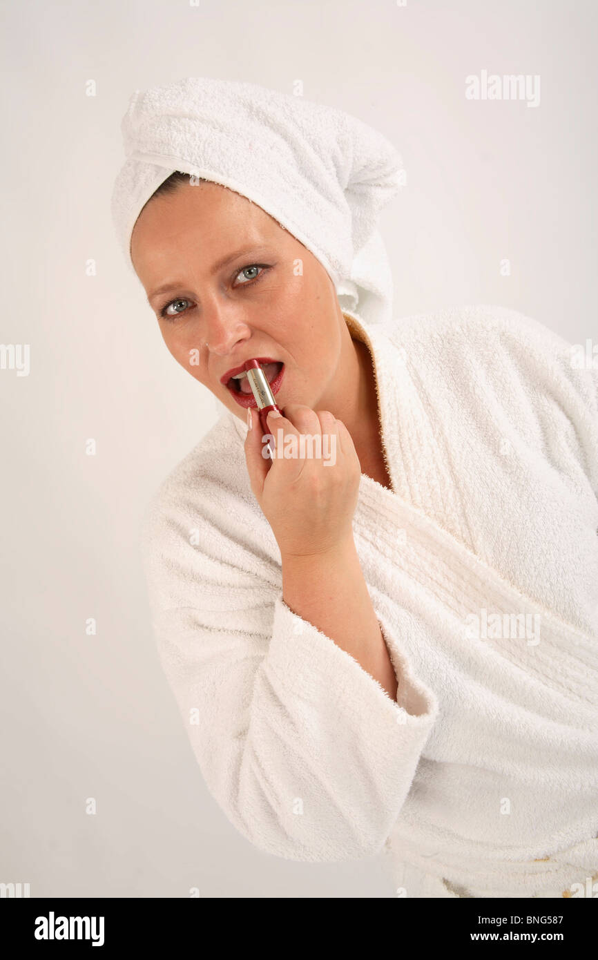 Woman applying make-up Stock Photo
