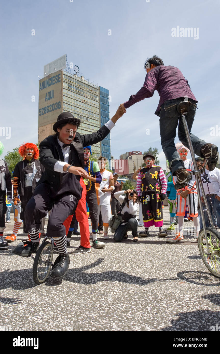 Clowns riding an unicycle during a clown parade in Mexico city with clowns from several countries Stock Photo