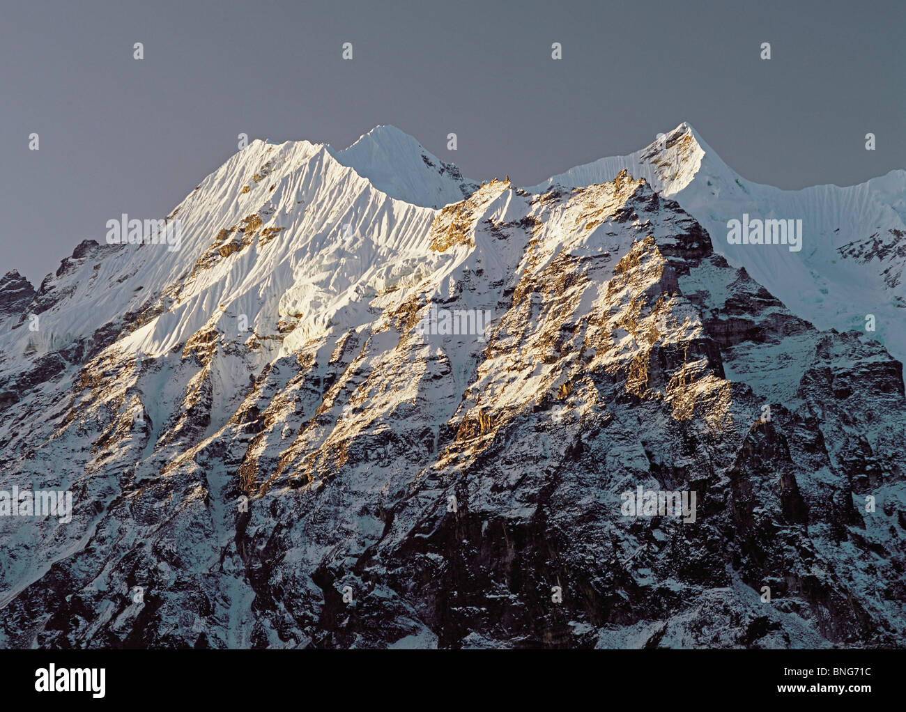 Early morning light on the ridge of peaks known as White Wave in the Kangchenjunga Himal of east Nepal Stock Photo