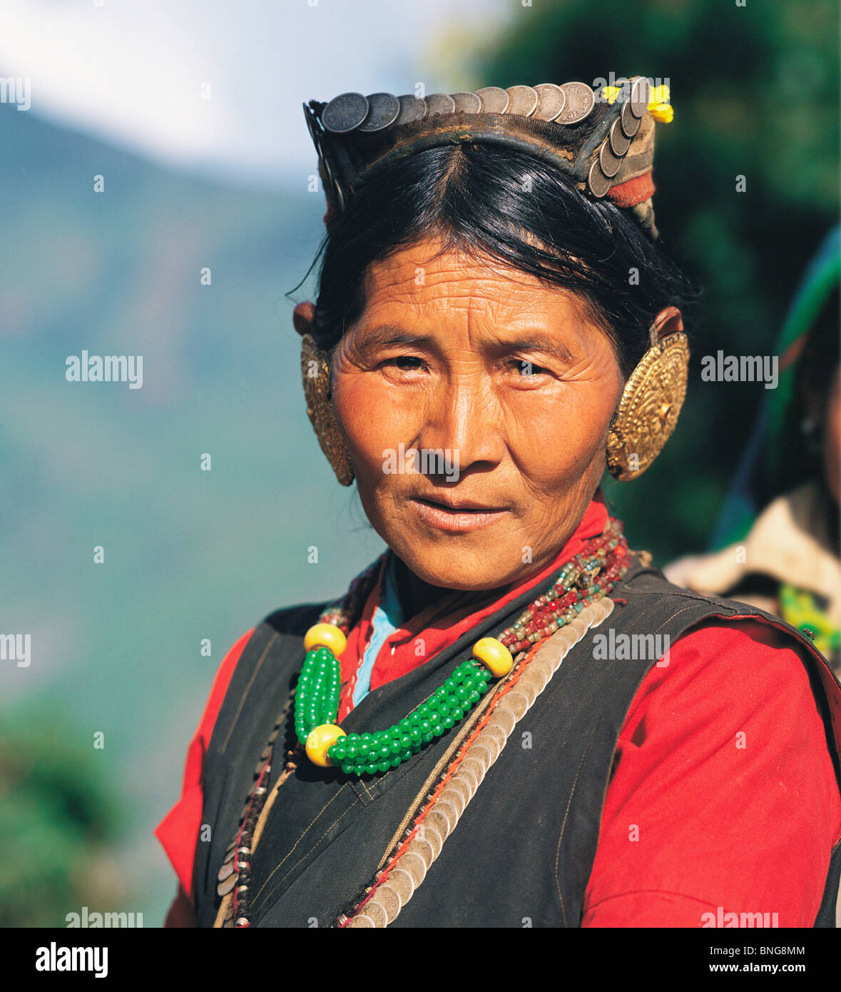 Sherpa woman wearing her best finery at a festival in the village of Seduwa in east Nepal Stock Photo