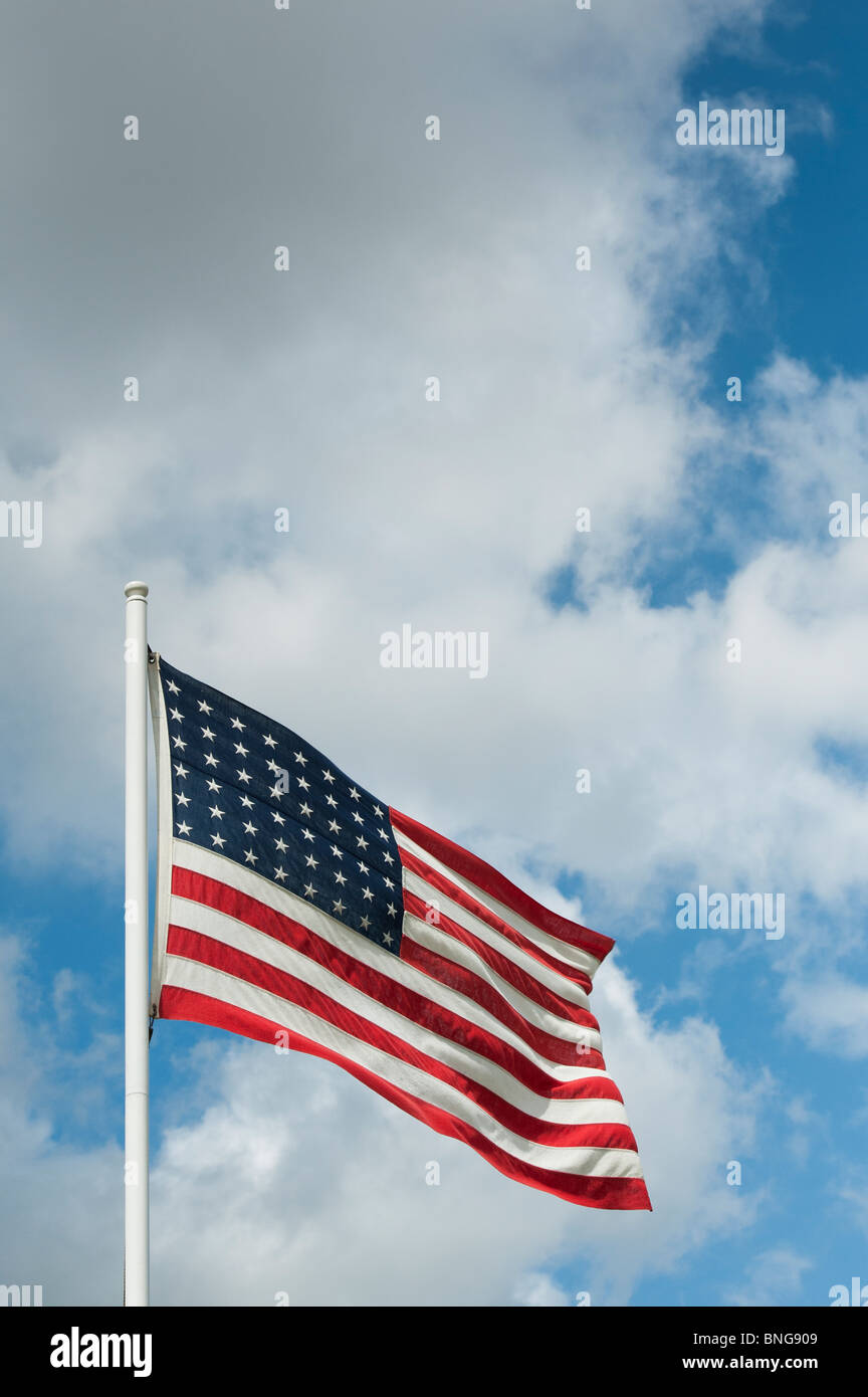American flag on a flagpole blowing in the wind Stock Photo
