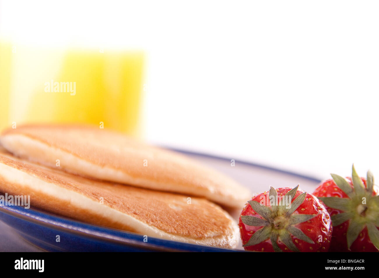 Healthy breakfast of pancakes, strawberries and orange juice with copyspace Stock Photo