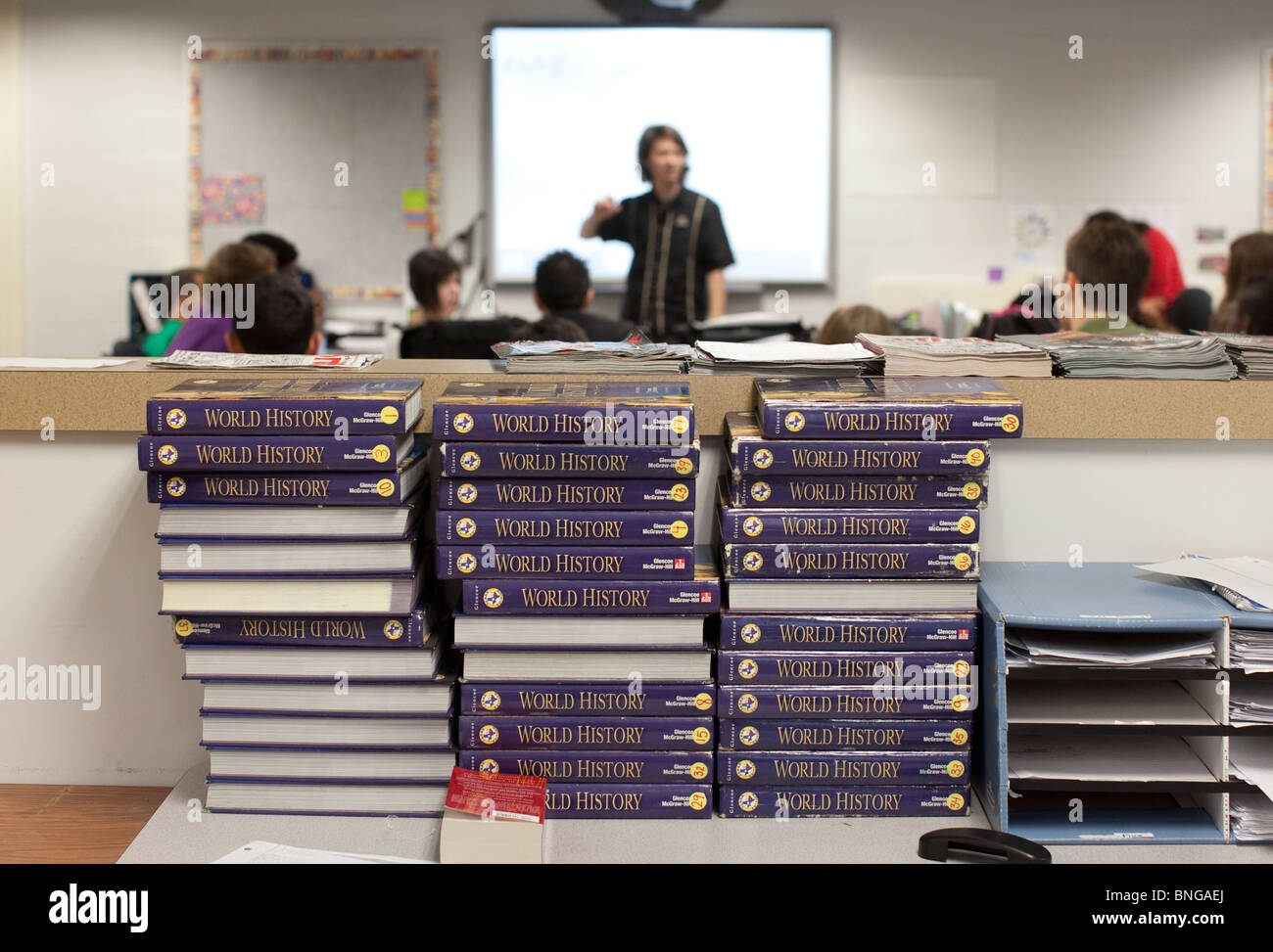 Unused world history books sit behind students  in class at Manor New Tech High School in Manor, Texas Stock Photo