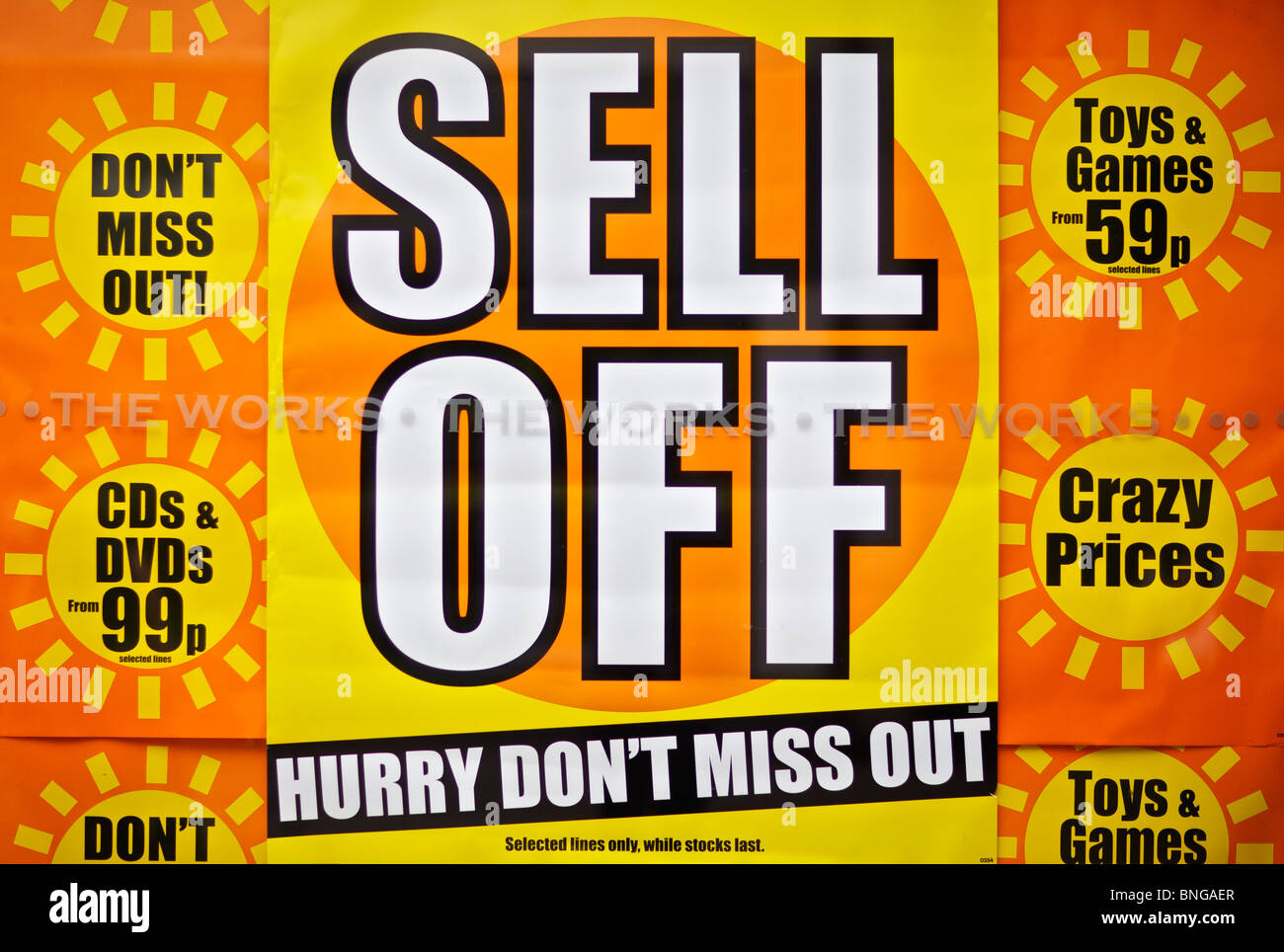 Sell off stock sale poster in shop window on High Street Stock Photo