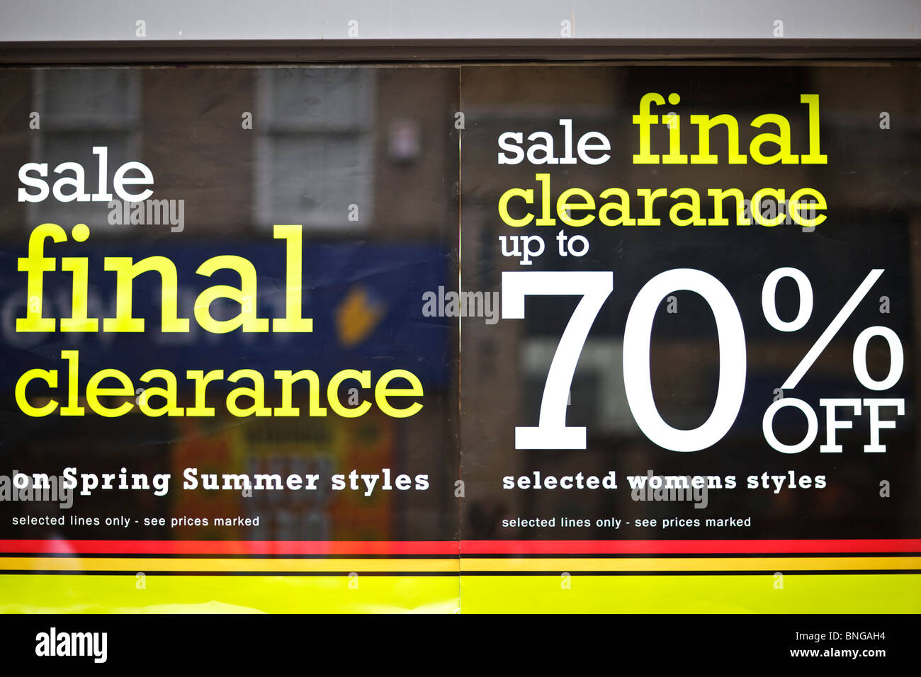 70% off final clearance sale posters in shoe shop window on High Street Stock Photo